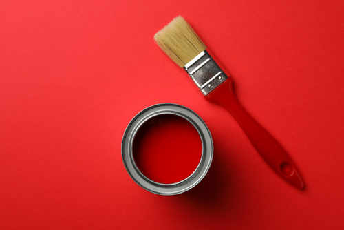 Paint,Can,And,Brush,On,Red,Background,,Top,View