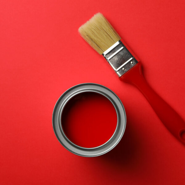 Paint,Can,And,Brush,On,Red,Background,,Top,View