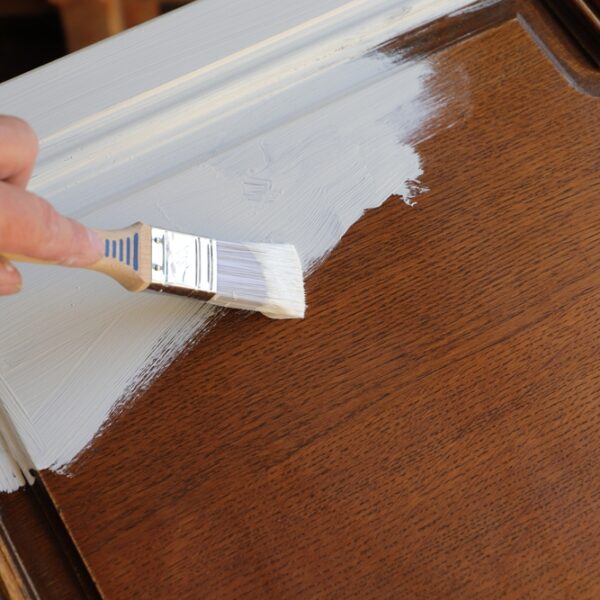 A,Brown,Kitchen,Cabinet,Is,Painted,With,White,Chalk,Paint